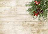 Christmas tree branch, decorations with holly on wooden board