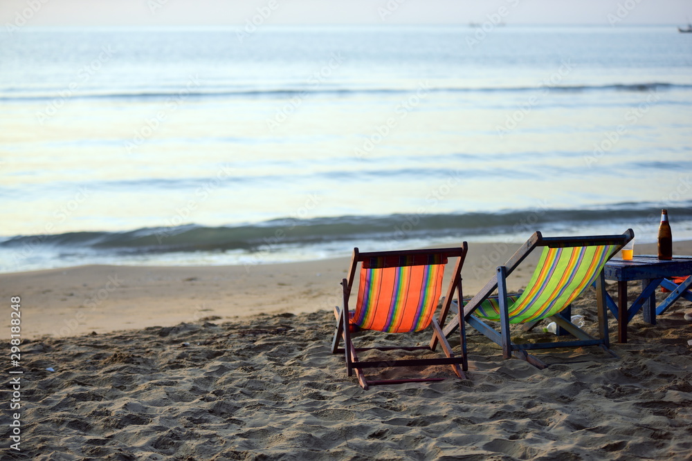 Sunrise view in the morning at the beach with Seaside lounge chair Sunrise view in the morning at the beach with Seaside lounge chair