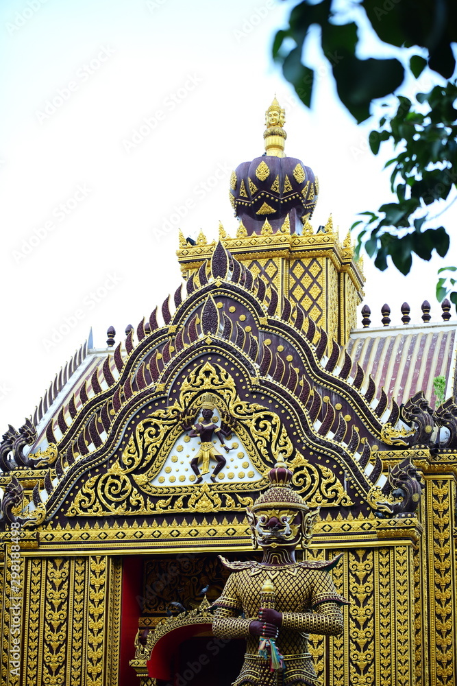 Beautiful thai temple decorated with sculptures an gold