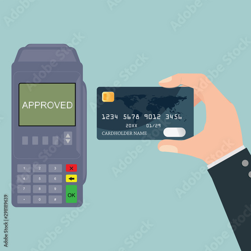 Hand holding credit card near POS terminal.