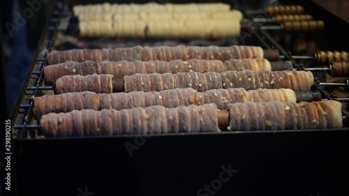 Traditional christmas food from Europe. Rolled dough christmas pastry top with sugar is also known under names Trdelnik, Prügelkrapfen, Baumstriezel, Baumkuchen, Baamkuch, Raguolis or Spettekaka.  photo