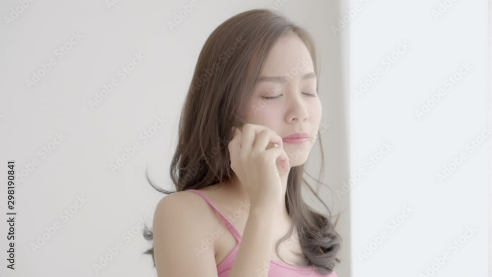 Beautiful young asian woman standing with problem stress in the bedroom, girl using mobile smart phone talking serious and tension with trouble, communication and social network concept. Beautiful young asian woman standing with problem stress in the bedroom, girl using mobile smart phone talking serious and tension with trouble, communication and social network concept.