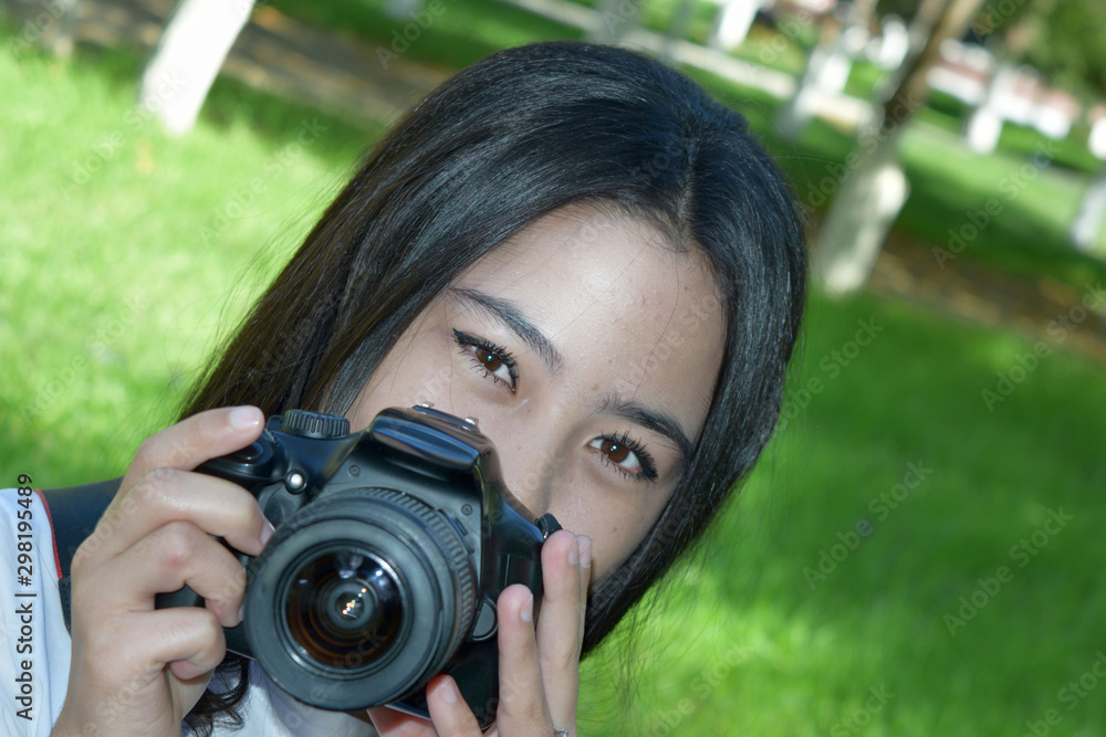 photo with the image of a beautiful young girl with a photo camera photo with the image of a beautiful young girl with a photo camera