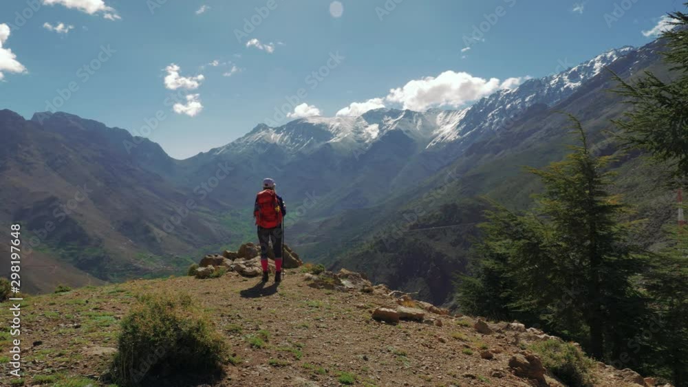 Backpacker girl in High Atlas mountains, Morocco, circular pan Backpacker girl in High Atlas mountains, Morocco, circular pan