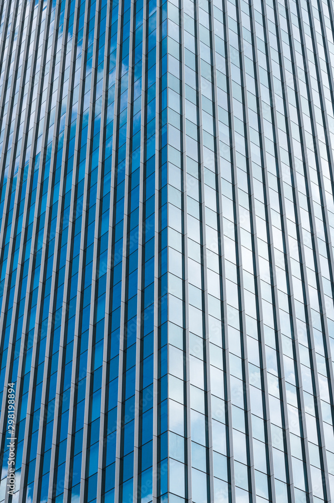 Abstract modern building with clouds reflected in windows glass.