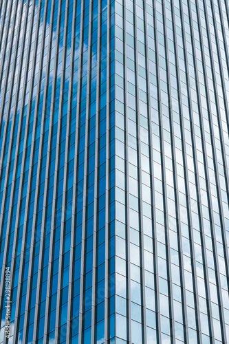 Abstract modern building with clouds reflected in windows glass.