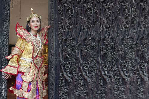 portrait of women in Mandalay traditional costume standing by wooden door