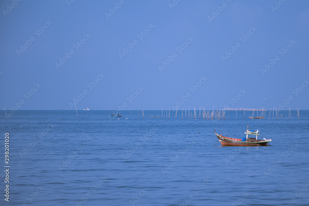 Fishing boats on the sea with blue sky background.Bang Saen Beach,Chonburi district,Thailand.	