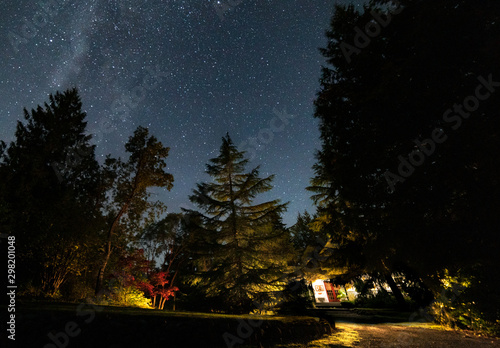 wilky way above a cabin in the woods photo