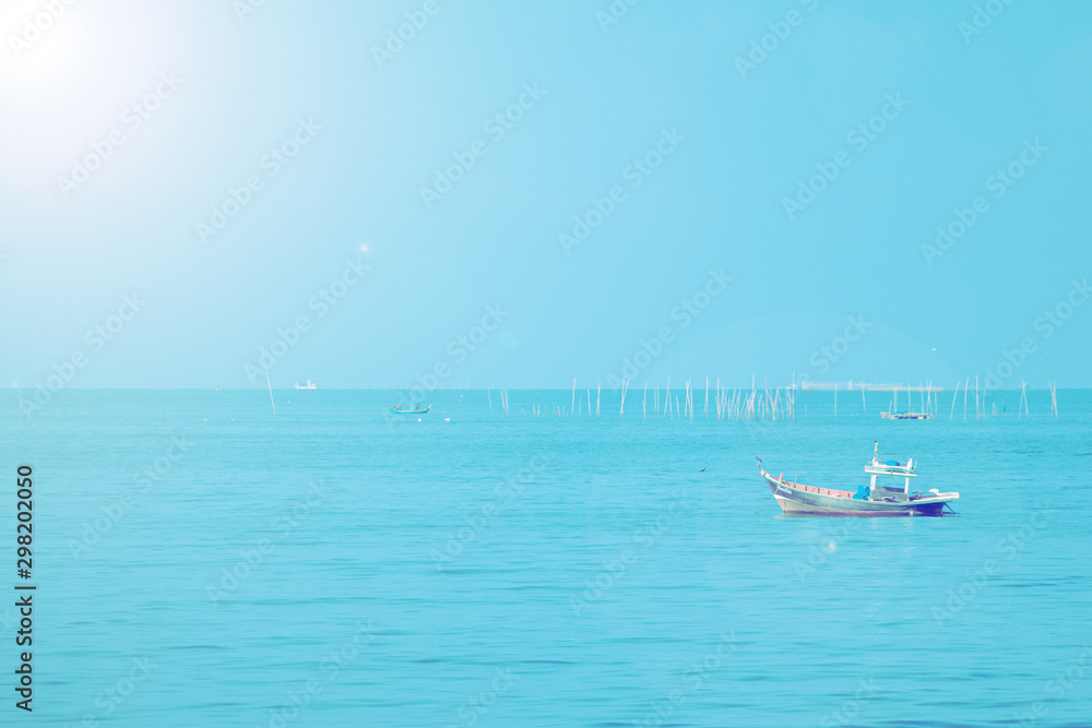 Fishing boats on the sea with blue sky  background.Bang Saen Beach,Chonburi district,Thailand.