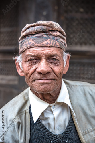 A middle-aged Asian man taking rest and smiling at the camera