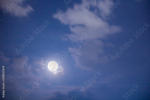 The photos of the moon and star in the night sky covered with clouds.