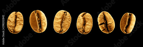 Six golden coffee beans isolated on a black background.