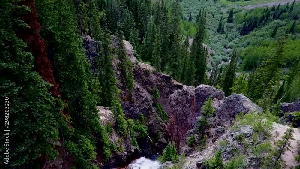 Aerial View of Waterfall Pouring into A Large Valley of Trees Aerial View of Waterfall Pouring into A Large Valley of Trees