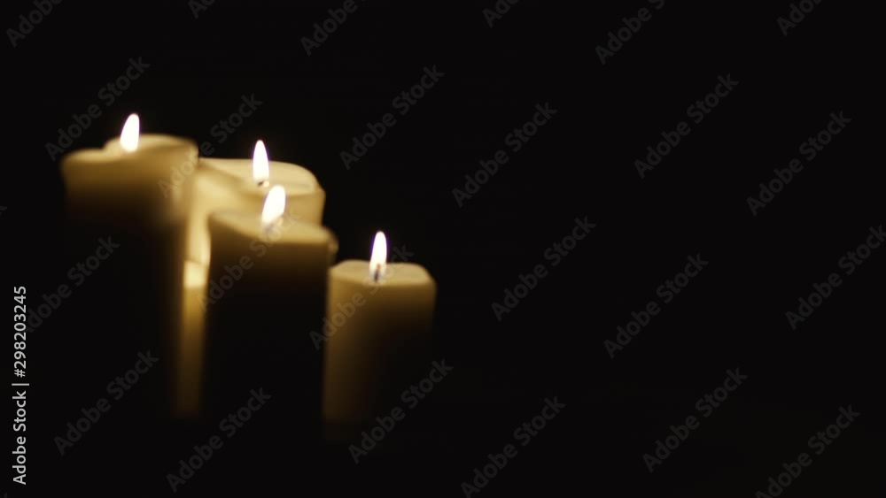 From left to right on fired candles, composition on black background, main element on the left, slow motion From left to right on fired candles, composition on black background, main element on the left, slow motion