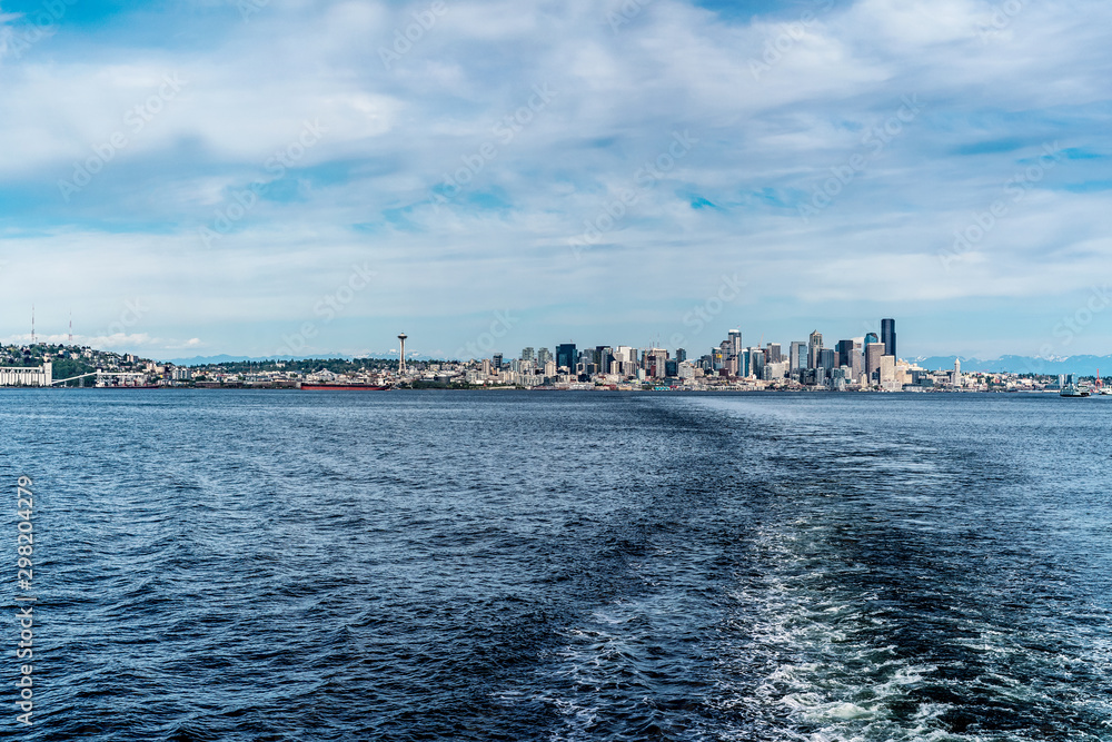A view of downtown Seattle on a cloudy afternoon from a ferryboat in Washington, United States.