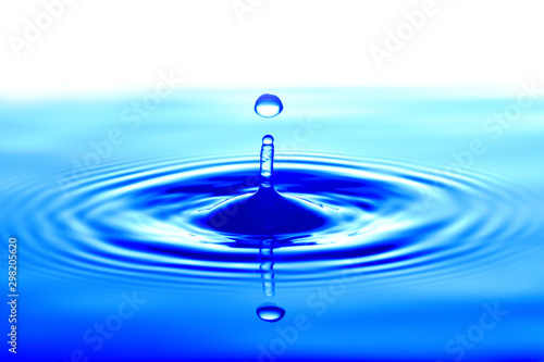 Splash of drop water in blue tone, blank spce from above to create concepttual.