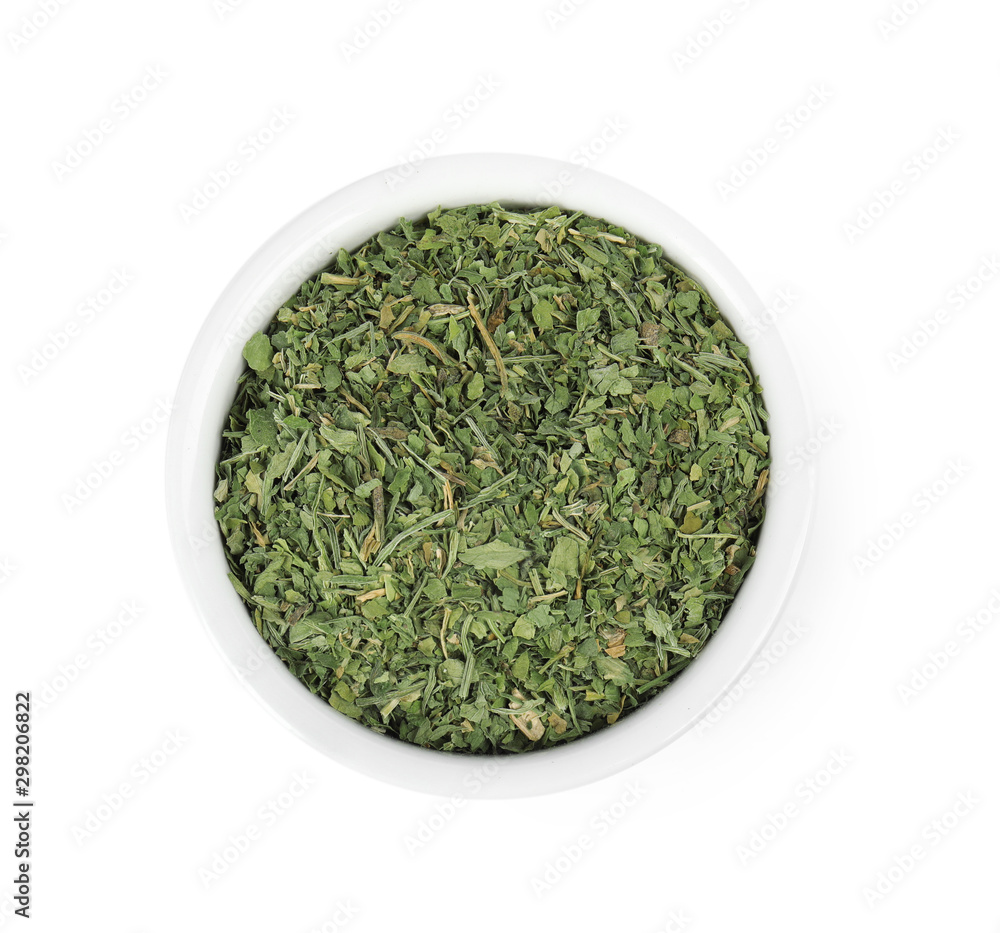 Bowl with dried parsley on white background, top view Bowl with dried parsley on white background, top view
