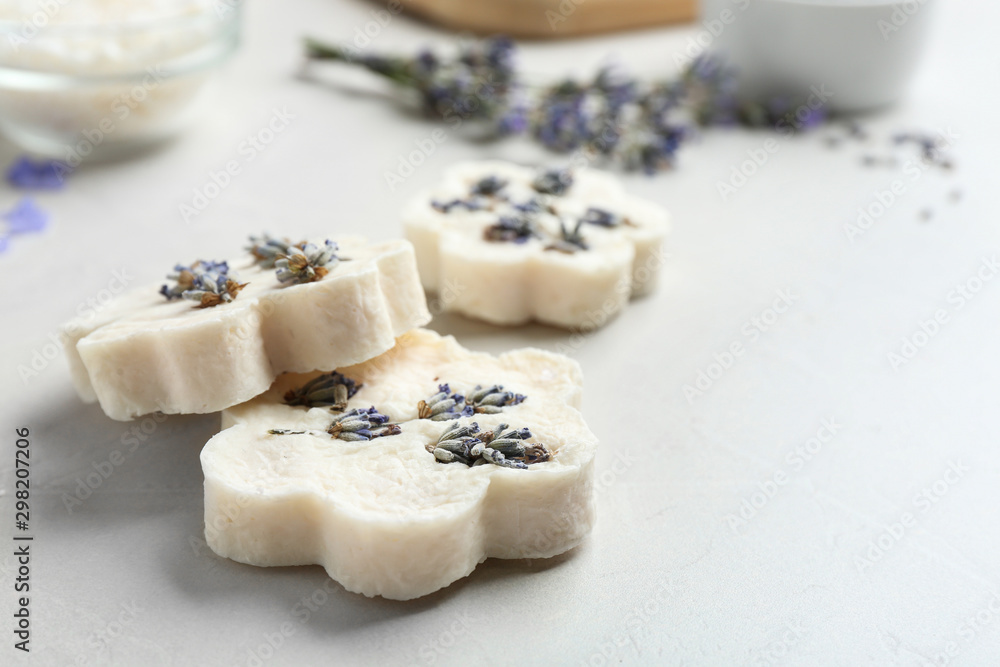 Hand made soap bars with lavender flowers on white table, closeup. Space for text