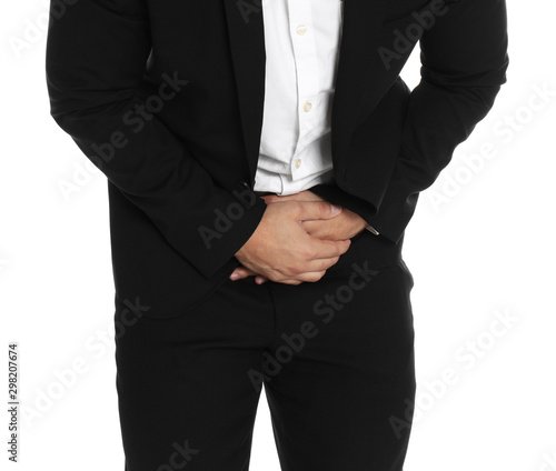 Businessman suffering from abdominal pain on white background, closeup