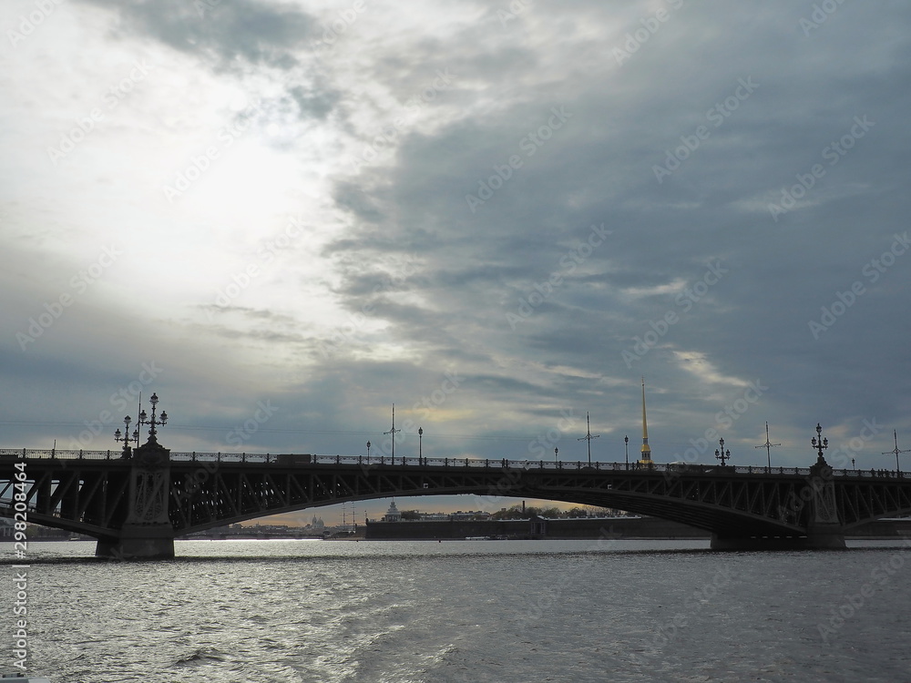 Fototapeta premium Landscape with Troitskiy Bridge and the Peter and Paul fortress on stormy day. Neva river, Saint-Petersburg. Selective focus.
