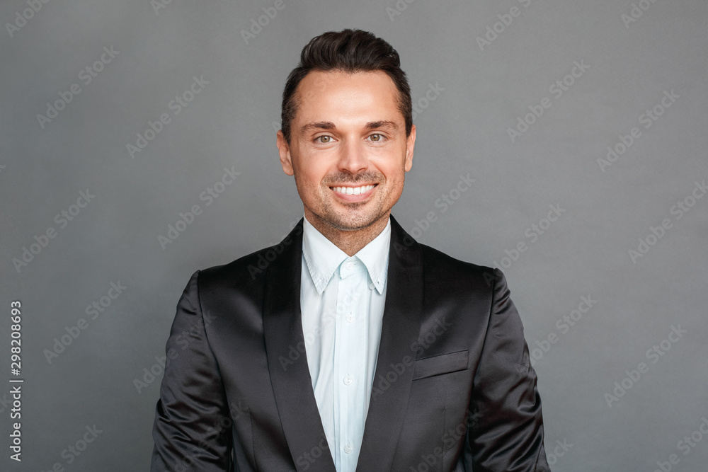 Businessman studio standing isolated on grey smiling toothy face close-up Businessman studio standing isolated on grey smiling toothy face close-up