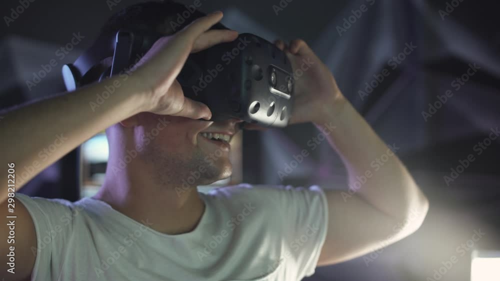 Modern interactive technologies, man puts on virtual reality glasses, exploring the virtual space, emotions of surprise. Modern interactive technologies, man puts on virtual reality glasses, exploring the virtual space, emotions of surprise.