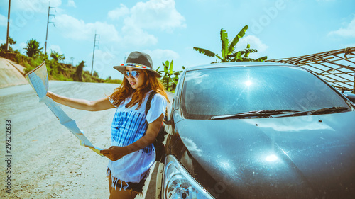 woman travel relaxing nature mountain map navigation. Travel relax in the holiday. View map travel explore. The girl standing view map travel explore beside the car. In Thailand
