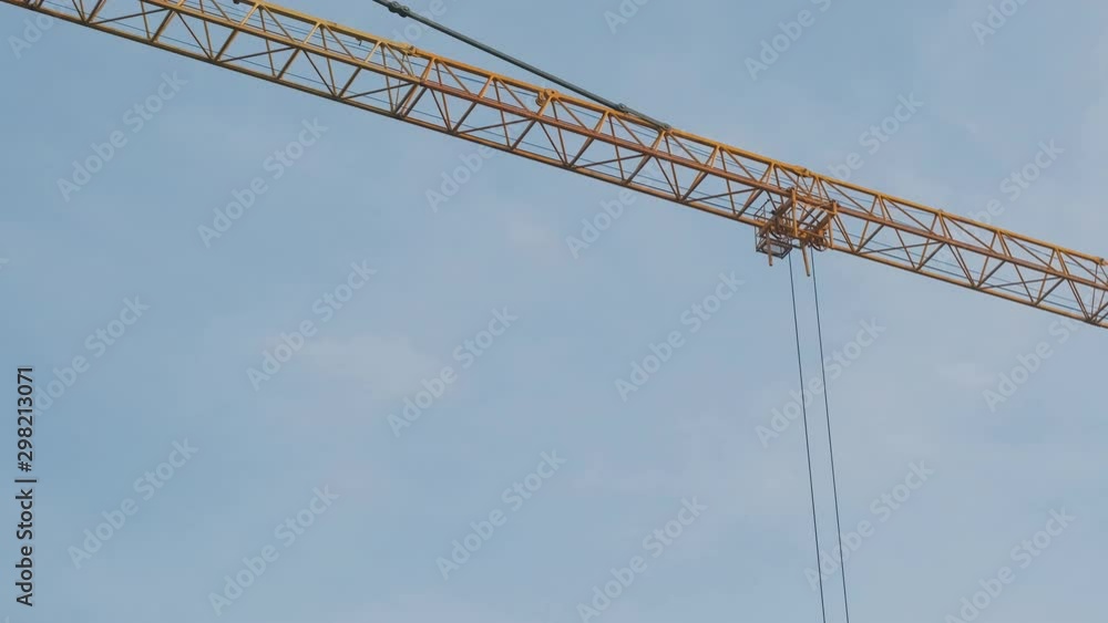 arm of a tall construction crane on a construction site arm of a tall construction crane on a construction site