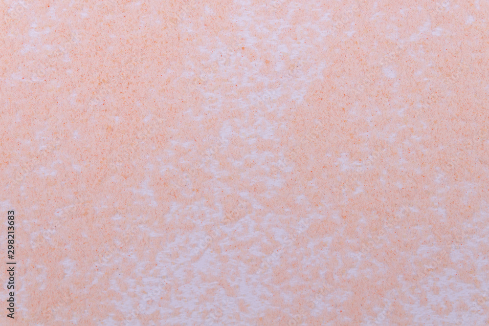 A background of grainy soft pale orange sand on white background