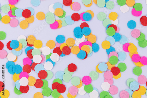 A pattern of colorful multicolored confetti scattered randomly on white background