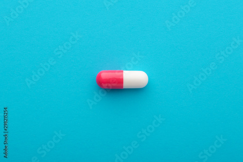 Pharmaceutical pill on blue background