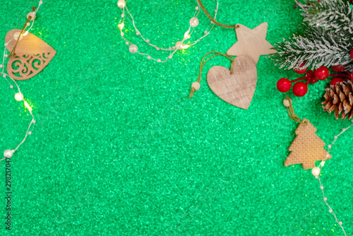 green Christmas background with space for text and wooden Christmas toys