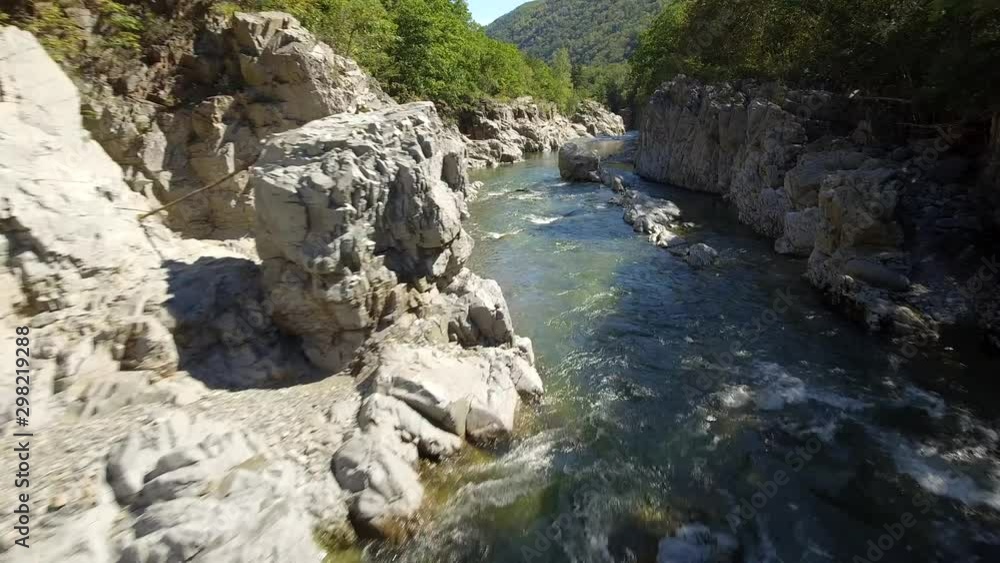 Epic fast aerial flight with stream of mountain river. Canyon colorful rocks. Russian wildness central Europe. Fishing travel adventure hiking. Far East Vladivostok. Drone cinematic Epic fast aerial flight with stream of mountain river. Canyon colorful rocks. Russian wildness central Europe. Fishing travel adventure hiking. Far East Vladivostok. Drone cinematic