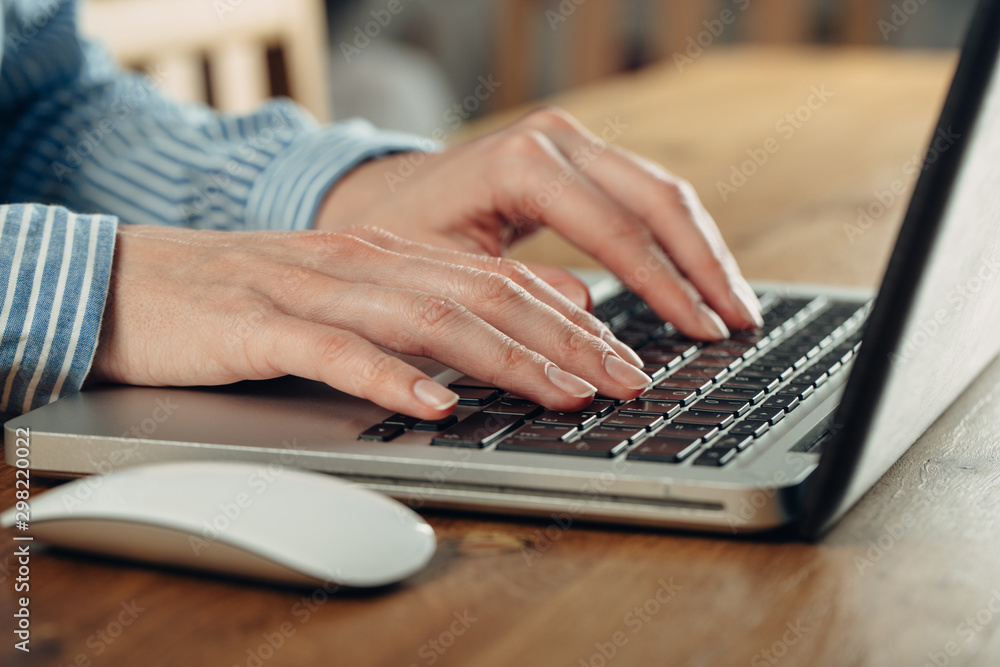 Woman working at home office hand on keyboard close up Woman working at home office hand on keyboard close up