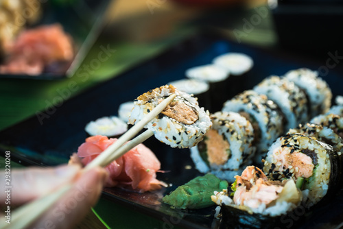 Sushi Set. Various rolls on a wooden plate. On dark rustic background