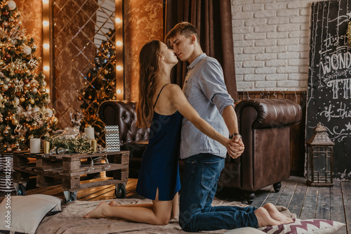 Romantic couple in love feeling happiness about their romance spending christmas eve together- Image