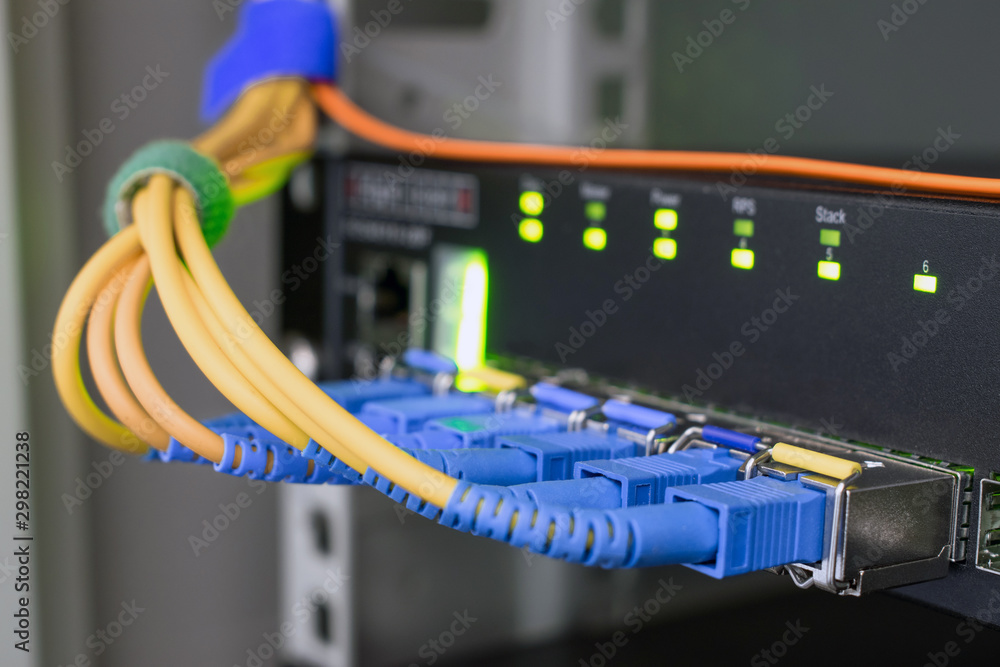 The modules for high-speed server interface are close-ups. Technological concept of data transfer. Fiber optic internet wires are connected to the ports of an access network switch The modules for high-speed server interface are close-ups. Technological concept of data transfer. Fiber optic internet wires are connected to the ports of an access network switch