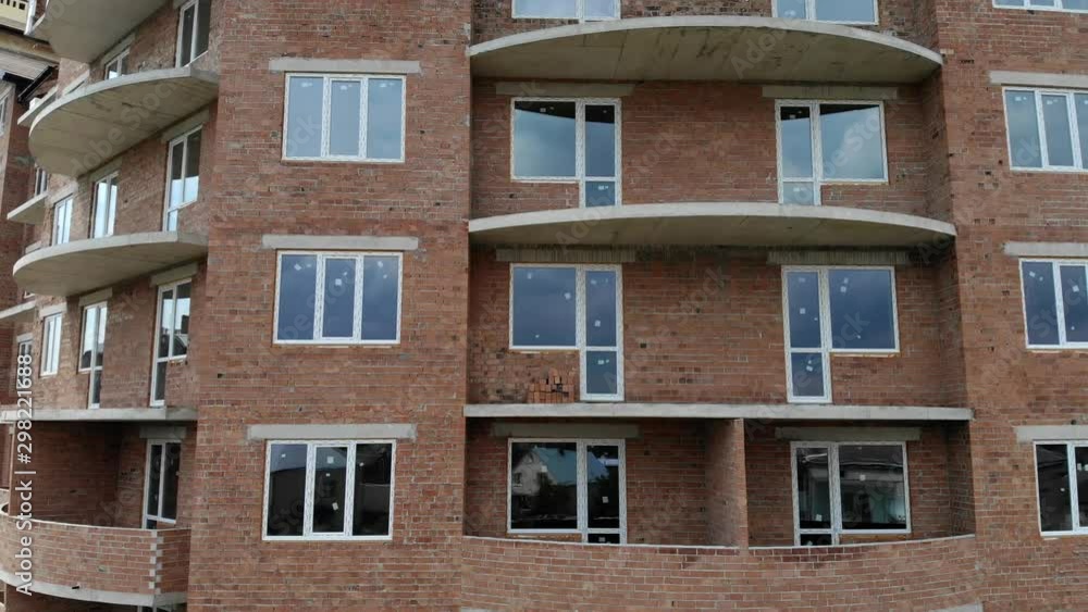 Aerial Construction of a brick house. Installation of wooden roof Aerial Construction of a brick house. Installation of wooden roof