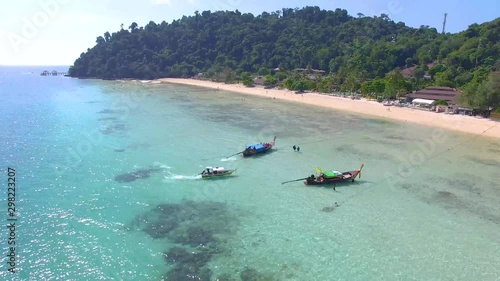 ARIAL: longtail boat by the beach, in thailand photo