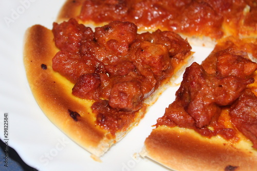 Delicious spicy meat pizza cut into slices