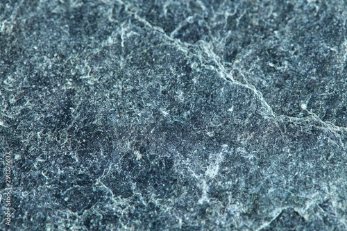Grainy texture of greenish-gray natural stone. Natural backgrounds and textures. Decor and design. Construction and finishing.