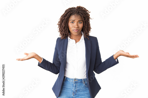 Fotografie Upset puzzled businesswoman making do not know gesture