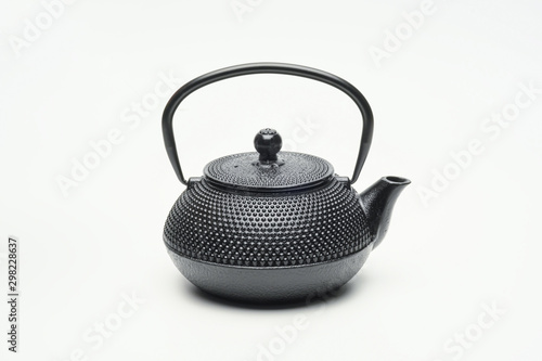 Black cast iron teapot on a white background. photo