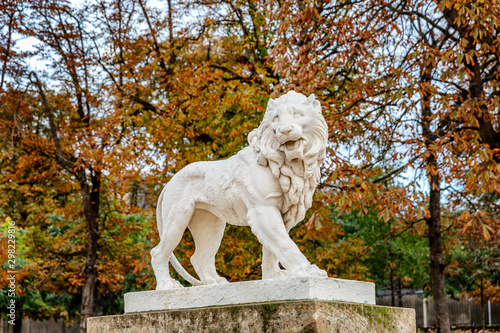 Lion statue in a city autumn park in Paris. Close-up.