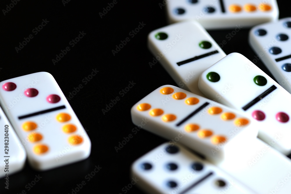 White domino on a black background close-up