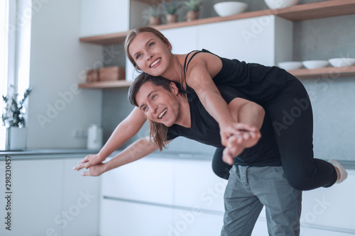 loving young couple having fun in their kitchen.