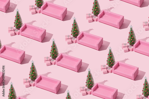 Christmas composition. Pink sofa, Christmas tree with presents on pink background. Winter holidays, new year minimal concept.