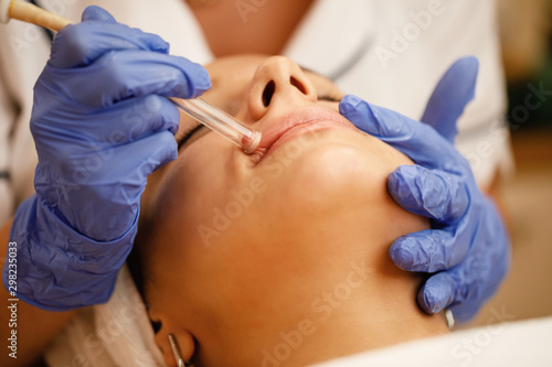 Close-up of woman having vacuum facial treatment at beauty spa 