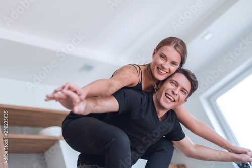 young married couple having fun in their new kitchen